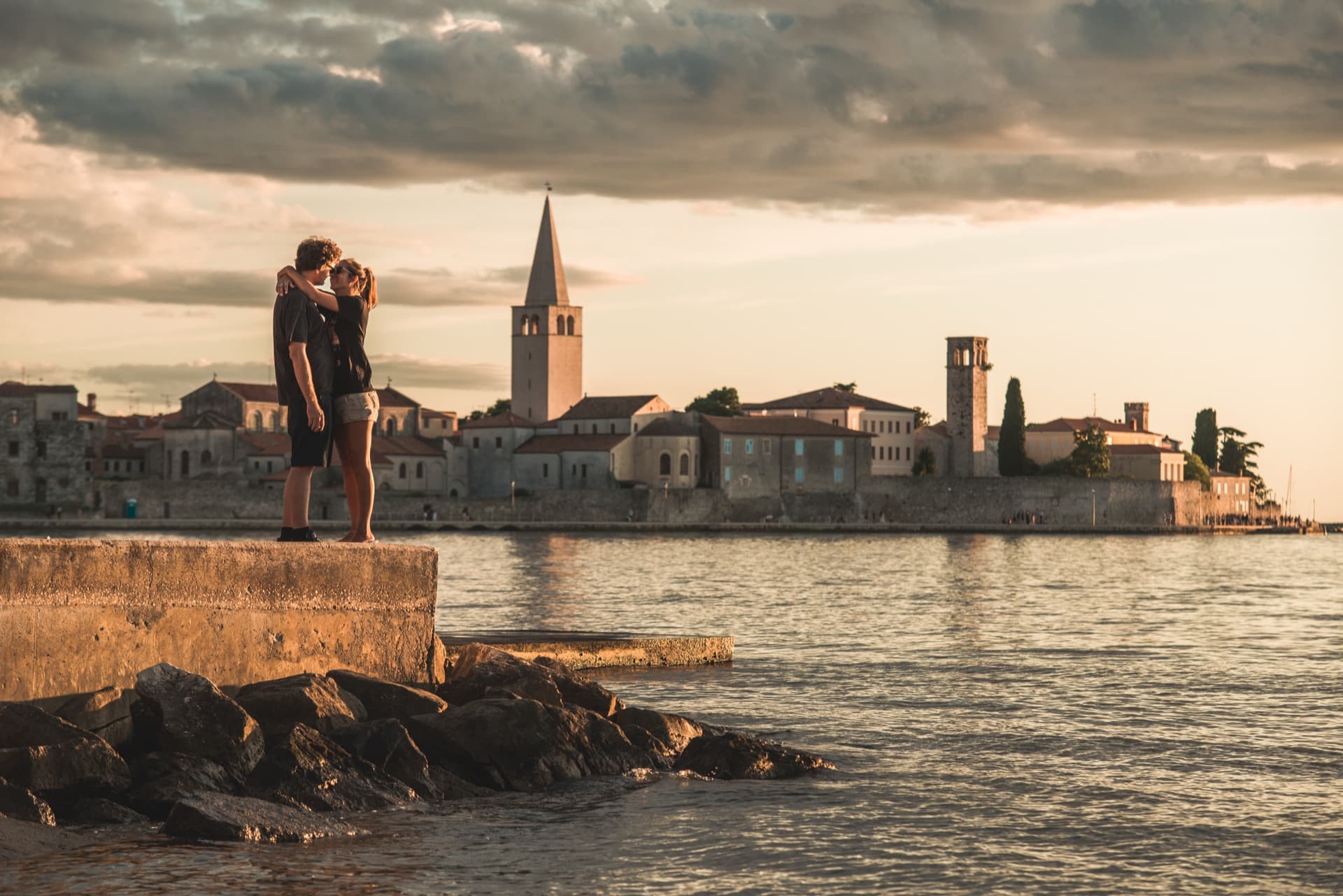 Golden afternoon light over Istrian coastline with a family laughing on the shore