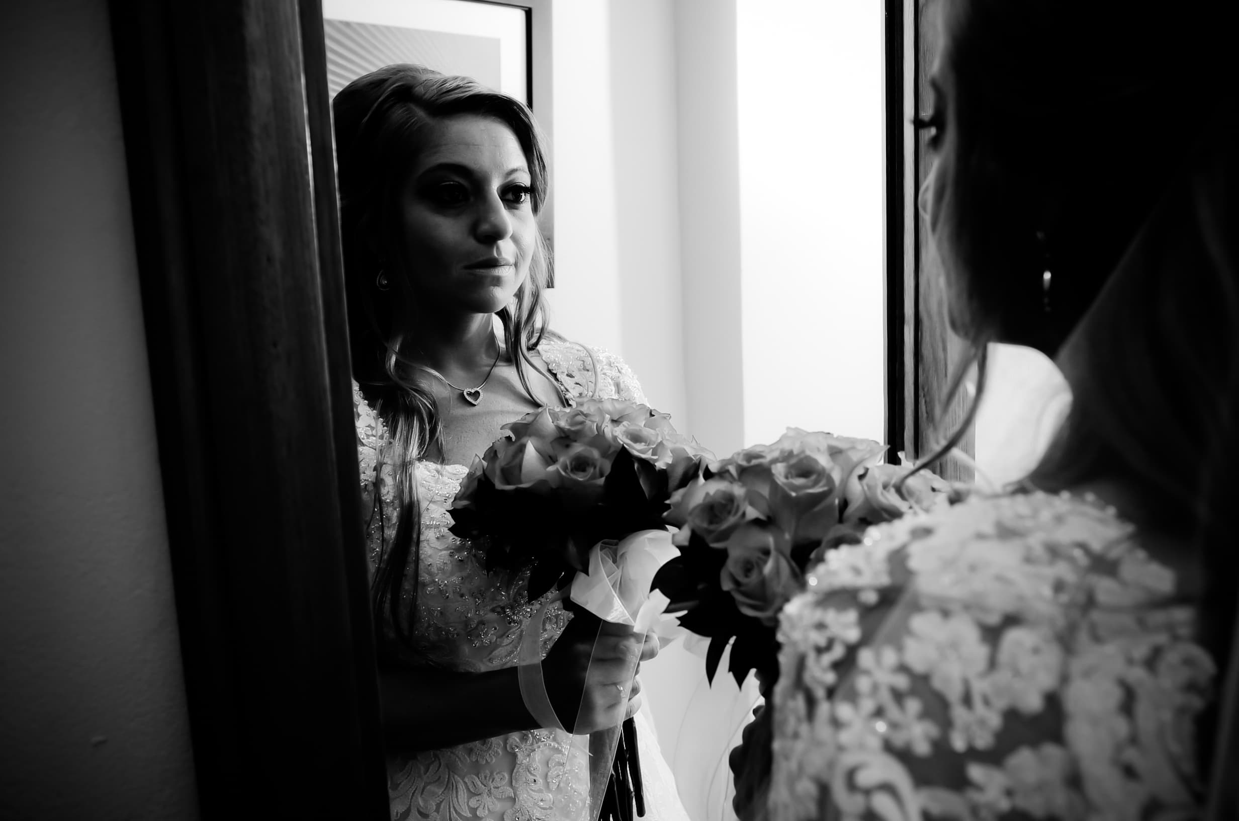 Bride and groom walking through a vineyard at dusk in golden Istrian light
