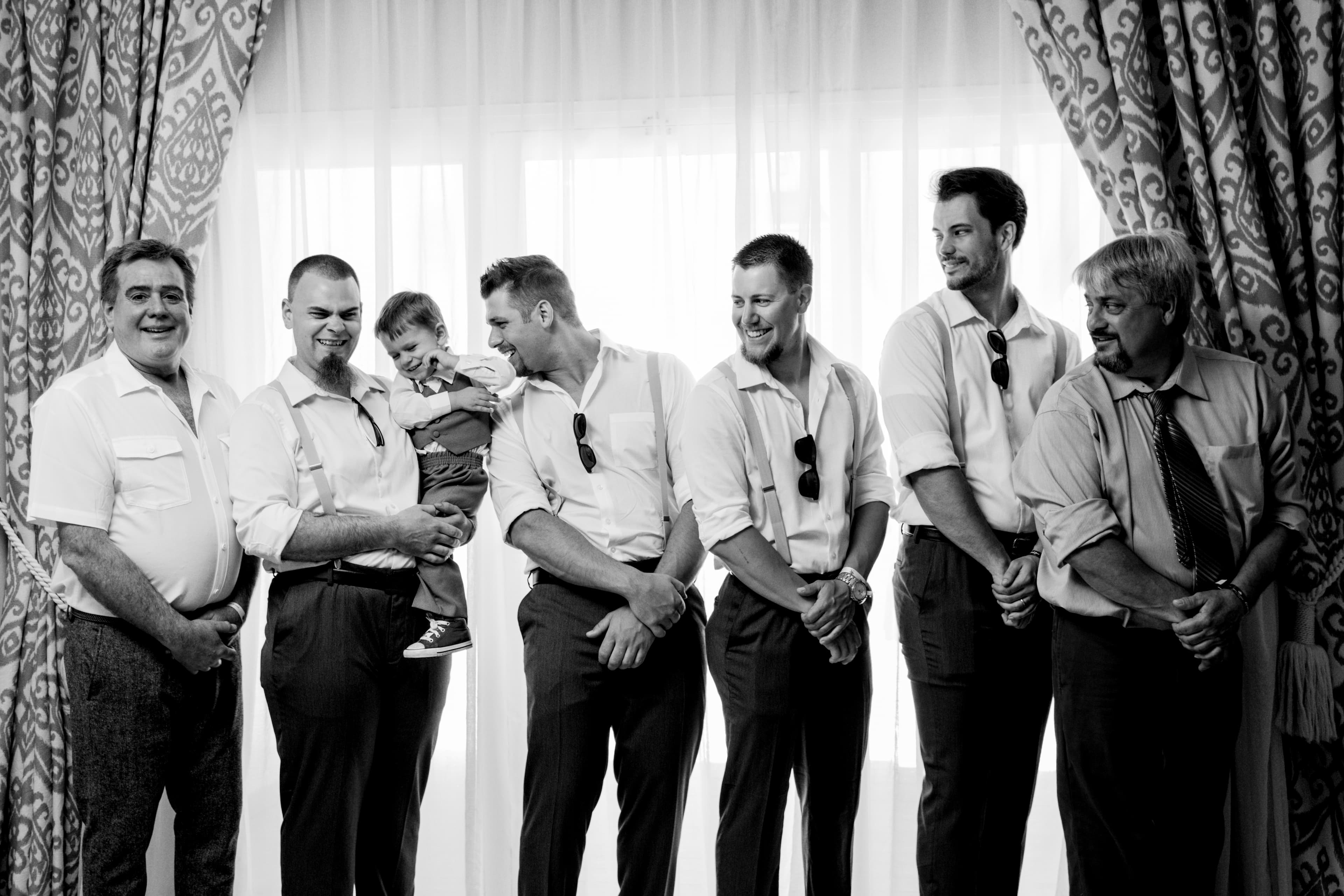 Bride and groom walking through a vineyard at dusk in golden Istrian light