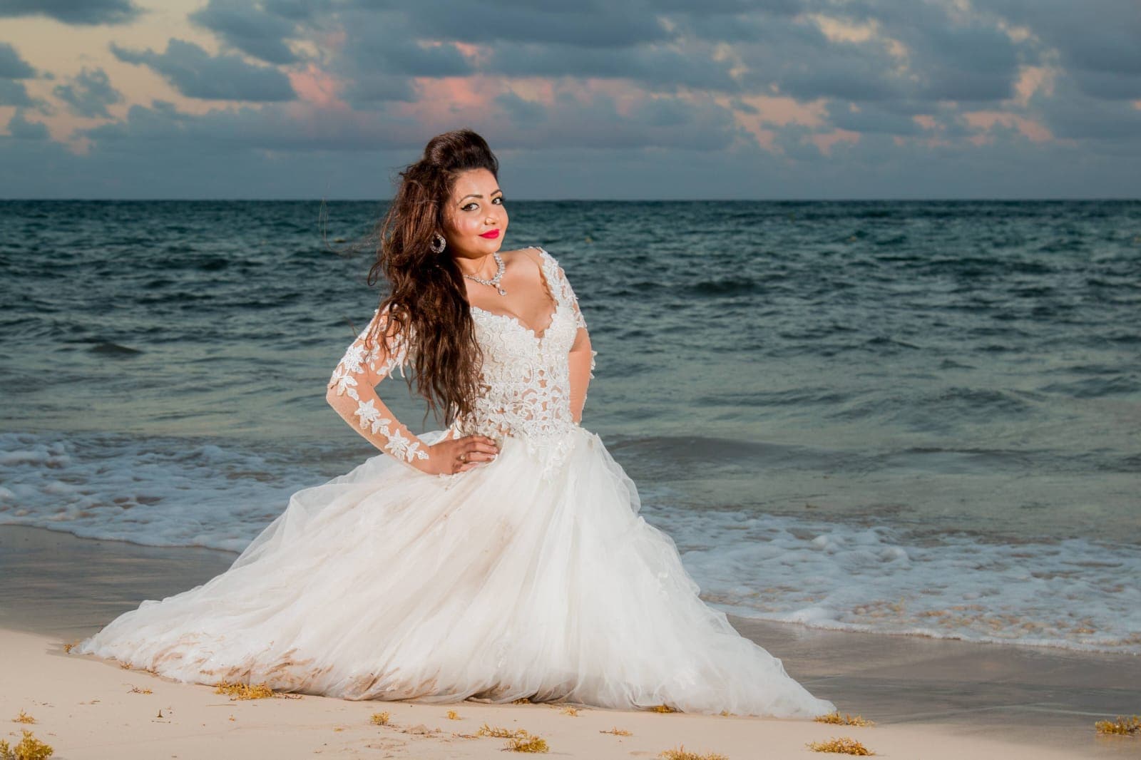 Bride and groom walking through a vineyard at dusk in golden Istrian light