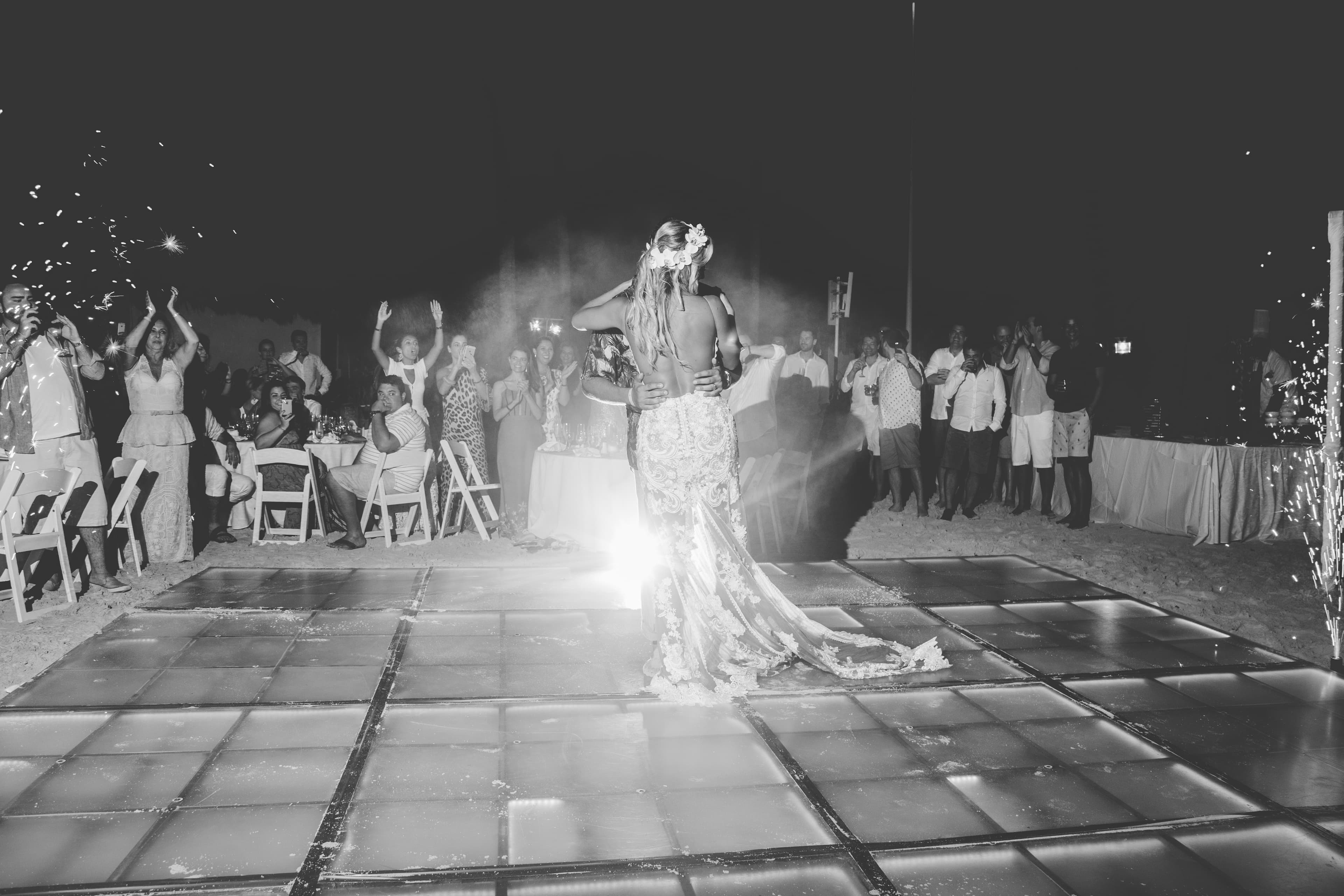 Bride and groom walking through a vineyard at dusk in golden Istrian light